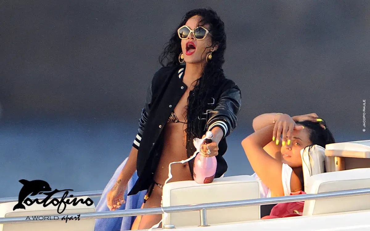 Rihanna is seen opening a bottle on a boat on July 28, 2012 in Portofino, Italy