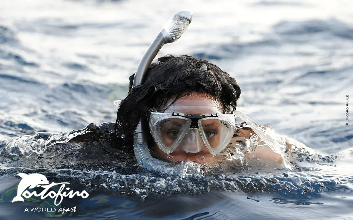 rihanna snorkeling in front of portofino lighthouse