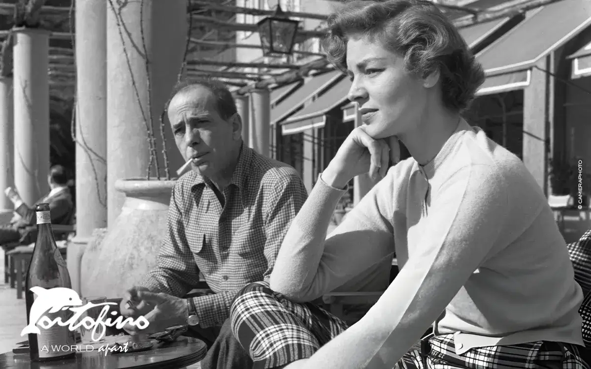 Humphrey DeForest Bogat with his wife Lauren Bacall, sitting outside a cafe in Portofino,1954.