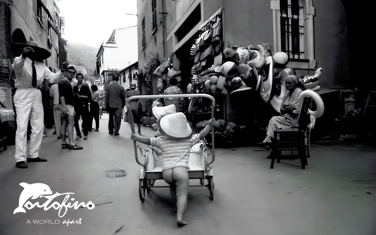 A Swedish little girl pushing his brother's stroller Portofino, July 1960 © Ronchini